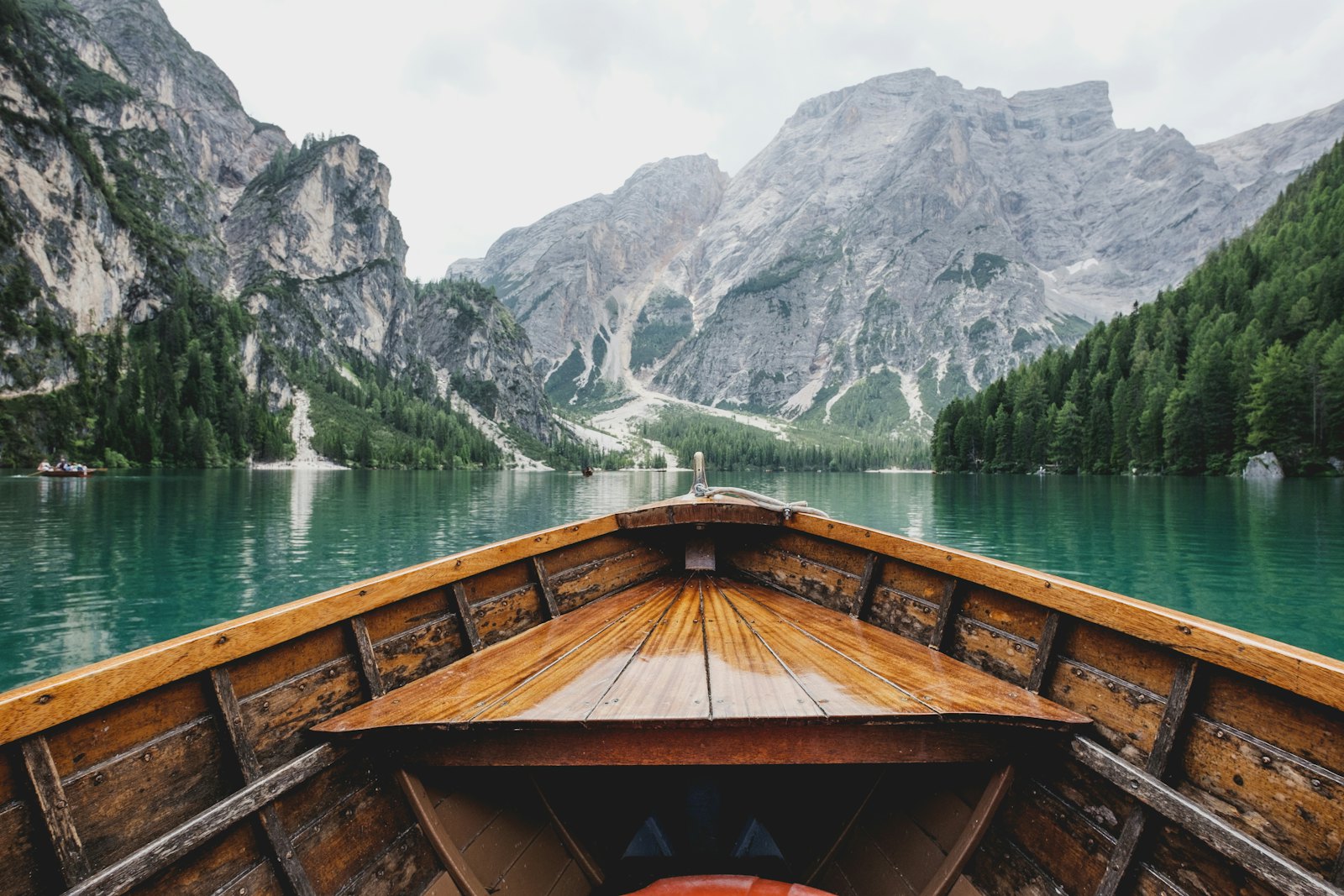 Boat on calm water between mountains