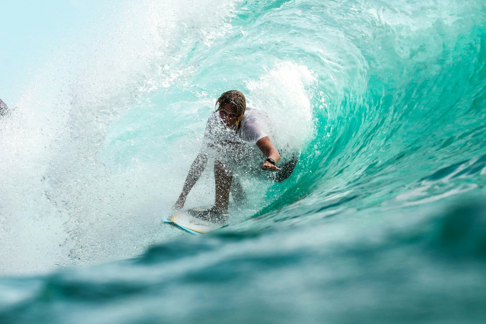 Surfer riding a wave, the kind of experience moment travellers book for