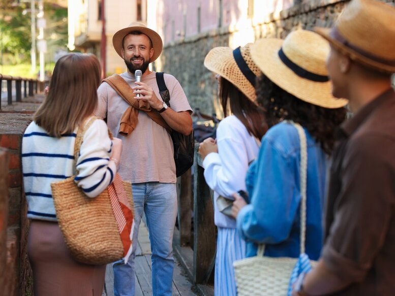 Tour guide with a group of happy tourists